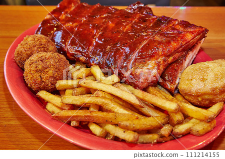 American Barbecue Platter with Pork Ribs and Sides on Red Plate American Barbecue Platter with Pork Ribs and Sides on Red Plate 111214155