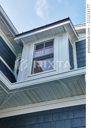 Bay Window Detail on Blue and Gray Sided Home, Upward View Bay Window Detail on Blue and Gray Sided Home, Upward View 111214177