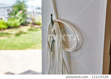 White Rope on Door Hook in Sunny Suburban Home 111214188