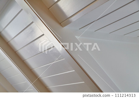Modern White Louvered Shutter Detail with Soft Light and Geometric Shadows 111214313