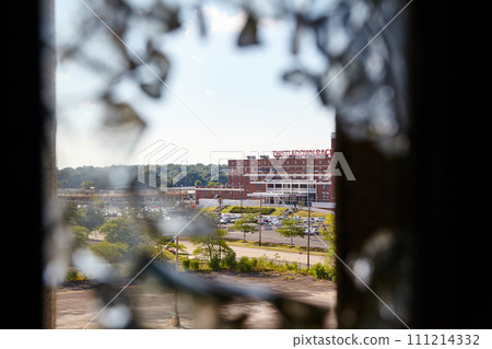 Abandoned Through Broken Glass with Red Brick Building, Sunny Urban, Framed View Abandoned Through Broken Glass with Red Brick Building, Sunny Urban, Framed View 111214332