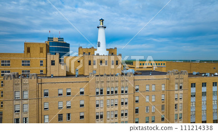 Aerial View of Urban Lighthouse and Vintage Building Against Cityscape 111214338