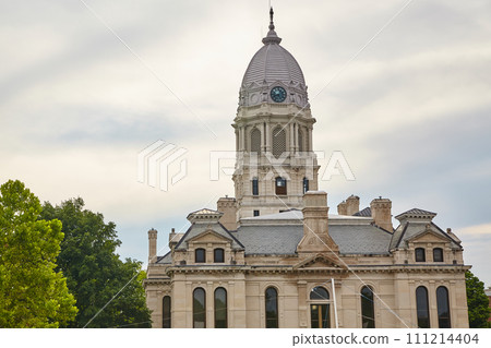 Classical Courthouse with Clock Tower and Lush Trees, Low Angle View Classical Courthouse with Clock Tower and Lush Trees, Low Angle View 111214404