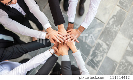 AI-generated content. top view of young people putting their hands together. Stack of hands showing unity and teamwork 111214412