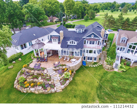 Aerial View of Luxurious Residential Estate with Lush Gardens and Patio 111214432