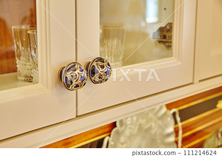 Vintage Blue and Gold Cabinet Knobs with Glassware Background 111214624