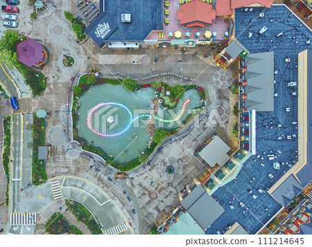 Aerial Top Down of Vibrant Entertainment Complex with Landscaped Pond 111214645