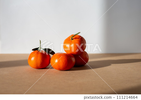 a group of tangerines sitting on top of a table, a still life, on light background, shiny finish,  111214664