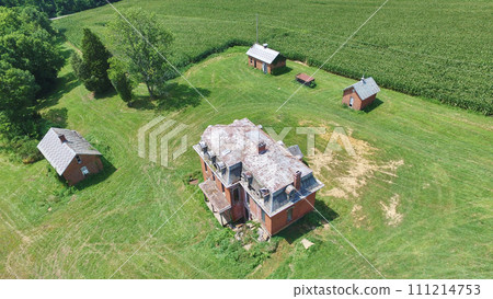Aerial View of Abandoned Rural Mansion with Lush Surroundings Aerial View of Abandoned Rural Mansion with Lush Surroundings 111214753