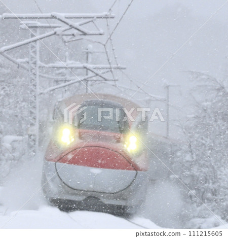 Akita Shinkansen running through Seniwa Pass in a blizzard 111215605