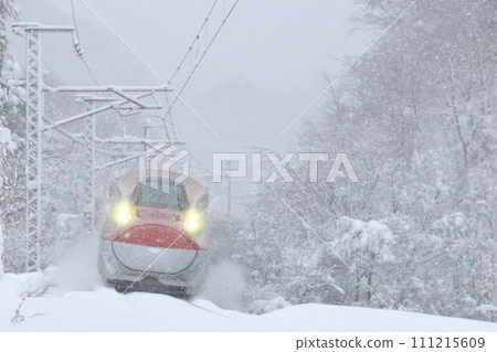 Akita Shinkansen running through Seniwa Pass in a blizzard Akita Shinkansen running through Seniwa Pass in a blizzard 111215609