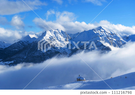 Mountain covered with snow and fog. Alpine landscape in Italy, Europe. Snow-capped mountains 111216798