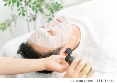 A man and an esthetician doing face packs, moisturizing, and treatments at men's facial beauty salon A man and an esthetician doing face packs, moisturizing, and treatments at men's facial beauty salon 111217258