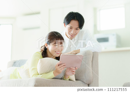 A couple looking at a tablet 111217555