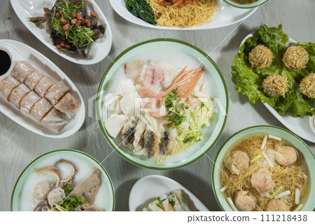 chinese breakfast assorted congee and rice skin side dishes with pork, shrimp and fish ball in restaurant 111218438