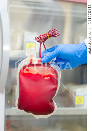 Red Blood bag with blue glove. 111220111