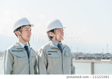 Workers wearing work clothes standing in the blue sky (construction, architecture, design, real estate, civil engineering, construction, site supervision, transportation) Workers wearing work clothes standing in the blue sky (construction, architecture, design, real estate, civil engineering, construction, site supervision, transportation) 111221081