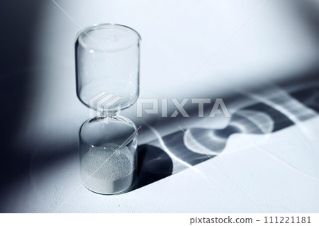 Hourglass on the desk, impressive light, shadow, and glass reflection 111221181