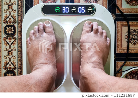 Closeup of person feet receiving magnetic therapy from electricity powered geomagnetic device, promising general well being benefits 111221697