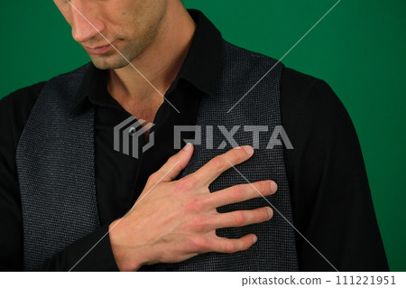 Young Man Holding A Hand To His Heart Due To This Pain emotions of a handsome man guy on a green background chromakey close-up dark hair young man Young Man Holding A Hand To His Heart Due To This Pain emotions of a handsome man guy on a green background chromakey close-up dark hair young man 111221951