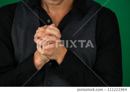 Hands on knees with crossed fingers of a man Hands on knees with crossed fingers of a man 111221964