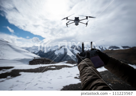 Flying drone in high altitude mountains Flying drone in high altitude mountains 111223567