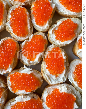 Baguette sandwiches with red salmon caviar and cheese. Top view. Baguette sandwiches with red salmon caviar and cheese. Top view. 111223723