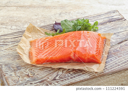 Raw salmon fillet over board 111224391