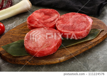 Delicous raw tuna medallion for cooking 111224576