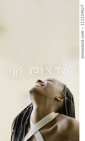 Young black woman looking up smiling Young black woman looking up smiling 111224627