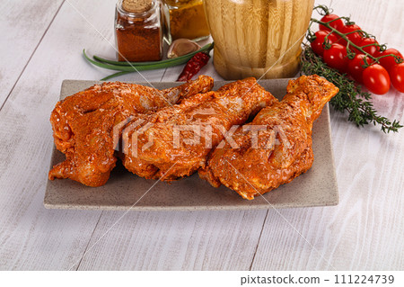 Raw turkey shoulder wing in Indian tandoori marinade 111224739