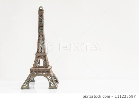 The Eiffel Tower figurine on a white background; copy space 111225597