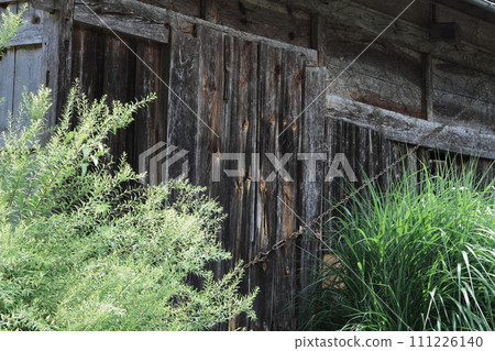 Old wooden wall of thatched old folk house 111226140