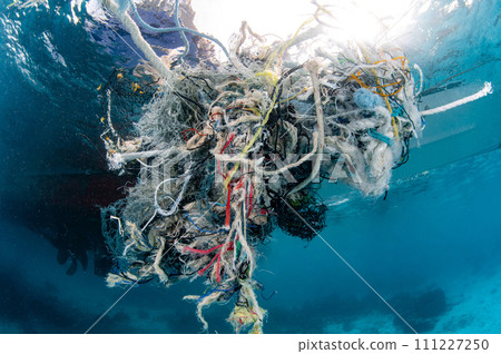 Abandoned fishing net and plastic garbage in the sea Abandoned fishing net and plastic garbage in the sea 111227250