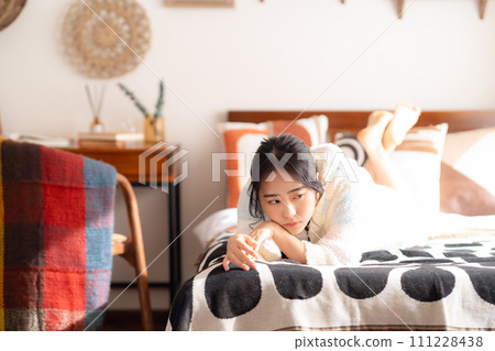 College woman relaxing on bed 111228438
