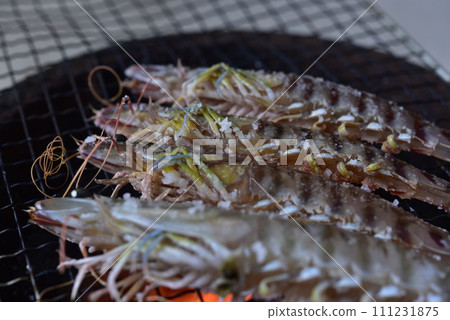 Prawns grilled on a charcoal grill Prawns grilled on a charcoal grill 111231875