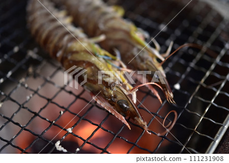 Prawns grilled on a charcoal grill 111231908