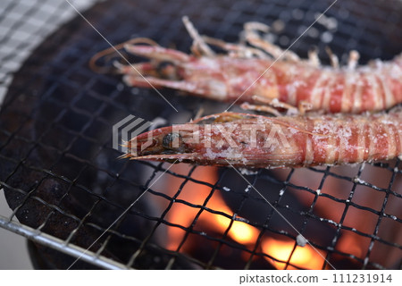Prawns grilled on a charcoal grill 111231914
