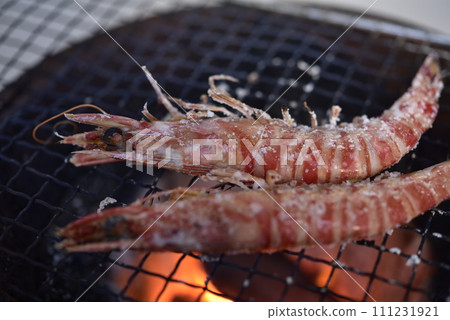 Prawns grilled on a charcoal grill 111231921