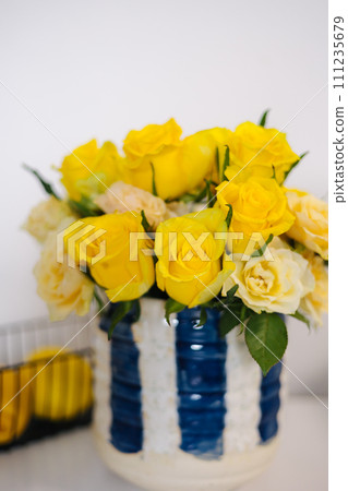 Bouquet of yellow and white roses in rustic handmade vase. Home mood. Woman's day Bouquet of yellow and white roses in rustic handmade vase. Home mood. Woman's day 111235679