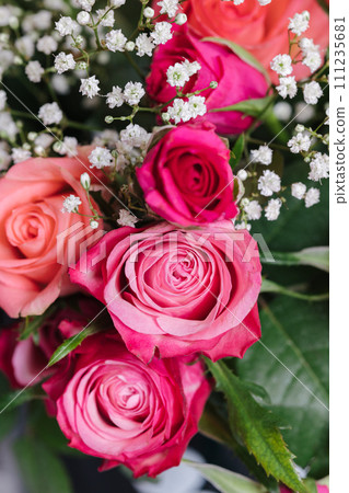 Bouquet of pink roses at home. Vase with flowers on the table 111235681