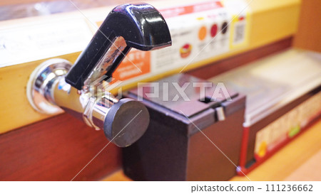 Hot water lever installed at a conveyor belt sushi restaurant 111236662