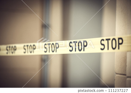 Yellow tape with the inscription stop. Barrier tape for fencing hazardous areas Yellow tape with the inscription stop. Barrier tape for fencing hazardous areas 111237227