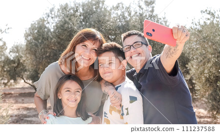 Family taking selfie during an excursion on a rural area 111237588
