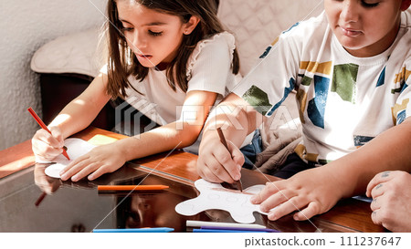 Children doing crafts at home with their mother 111237647
