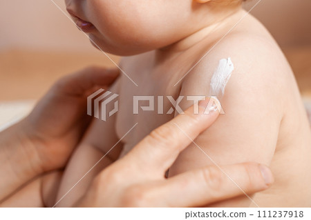 Father applying body cream on his baby 111237918