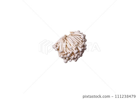 Small white edible beech mushrooms with salt and spices on a plain background Small white edible beech mushrooms with salt and spices on a plain background 111238479
