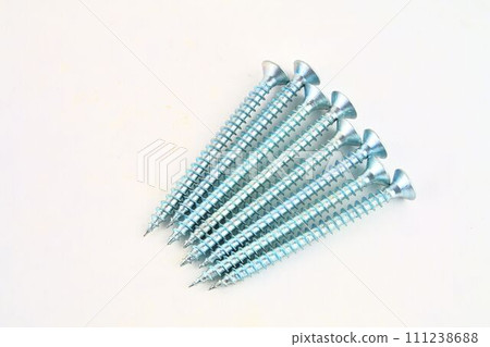 Set of screws for construction on a white background, metal screw, iron screw, chrome screw, screws as a background, wood screw. Close-up Set of screws for construction on a white background, metal screw, iron screw, chrome screw, screws as a background, wood screw. Close-up 111238688