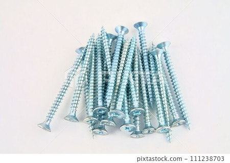 Set of screws for construction on a white background, metal screw, iron screw, chrome screw, screws as a background, wood screw. Close-up 111238703