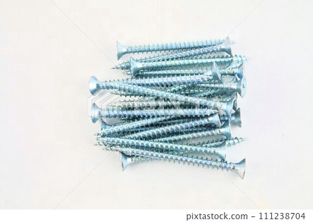 Screws for construction on a white background, metal screw, iron screw, chrome screw, screws as a background, wood screw. Close-up 111238704